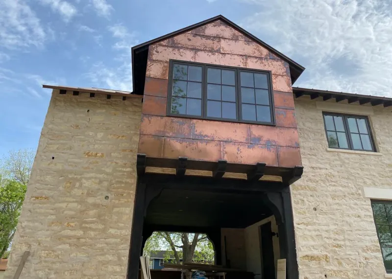 Copper metal panel facade on a stone building for Skylight Installation in Artesia